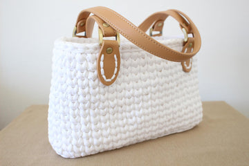 Handbag with leather straps