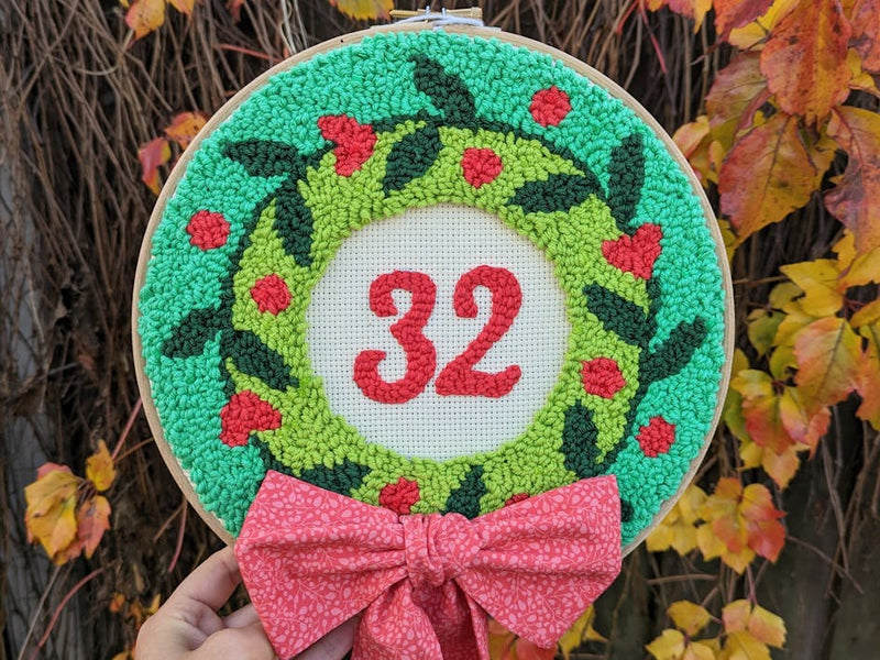 Learn how to make a jolly punch needle Christmas wreath