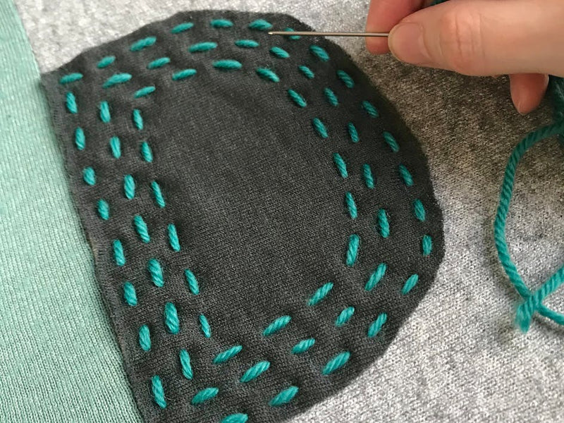 Upcycle old knitwear with hand embroidery and create a comfy cushion for your home