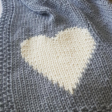 Chunky intarsia heart motif crib/pram blanket
