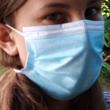 Crochet flower to hold facemask in place