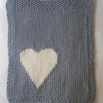 Chunky intarsia heart motif crib/pram blanket