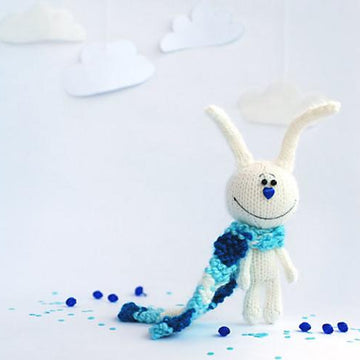 White rabbit in a blue striped scarf