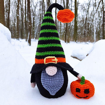 Halloween black gnome with pumpkin