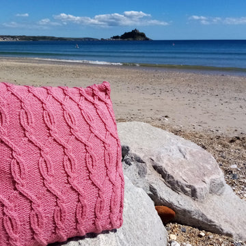 Two cabled aran cushion covers