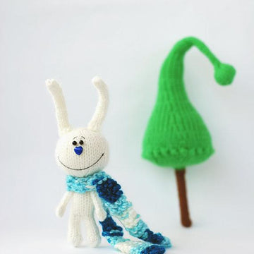 White rabbit in a blue striped scarf