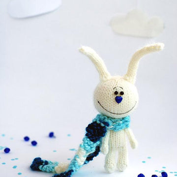 White rabbit in a blue striped scarf