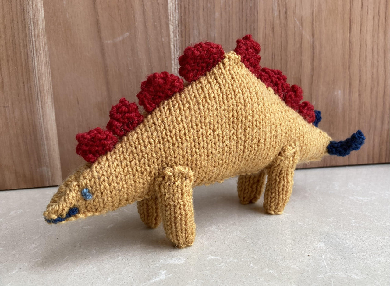 Stegosaurus and Triceratops knitted soft toys