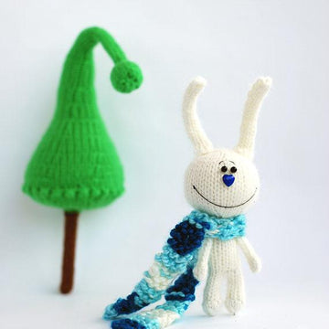 White rabbit in a blue striped scarf