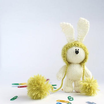 White rabbit in a light green hat