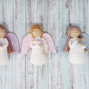 Miniature Angel holding baby