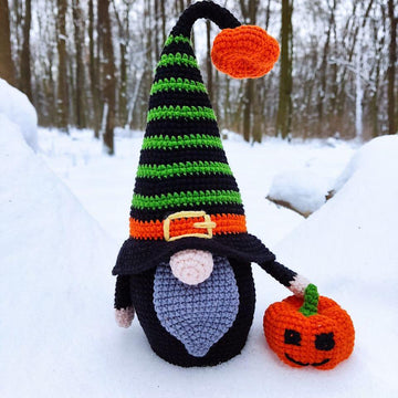 Halloween black gnome with pumpkin