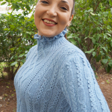 Ruffled neck cabled sweater