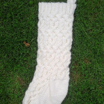 Three traditional knitted Christmas stockings