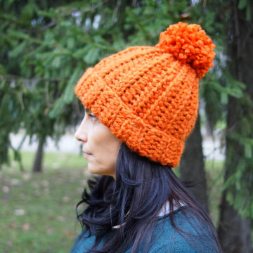 Knit look bulky hat with pom pom