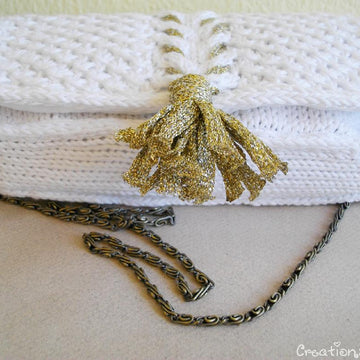White knit clutch with gold tassel