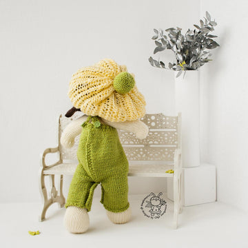 Baby doll in green overalls