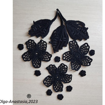 Crochet composition of flowers and leaves in black