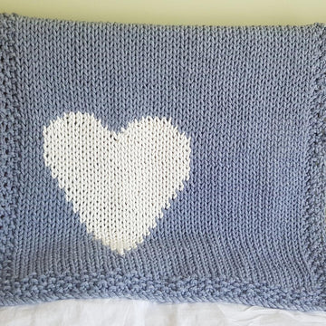 Chunky intarsia heart motif crib/pram blanket