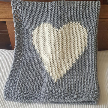 Chunky intarsia heart motif crib/pram blanket