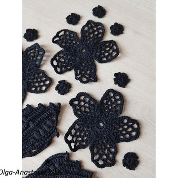 Crochet composition of flowers and leaves in black