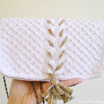 White knit clutch with gold tassel