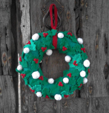 Knitted Christmas wreath with holly leaves, berries and snowballs