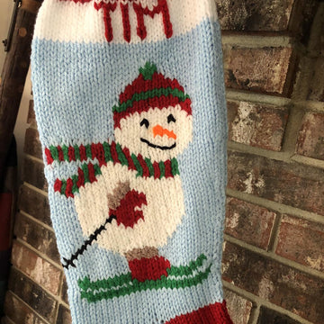 Snowman stocking on skis