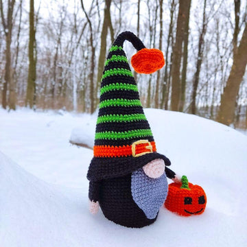 Halloween black gnome with pumpkin