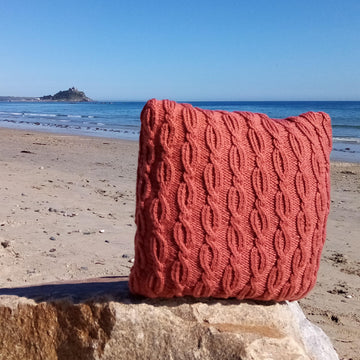 Two cabled aran cushion covers