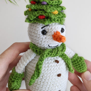 Crochet snowman in a Christmas tree hat amigurumi pattern