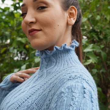Ruffled neck cabled sweater