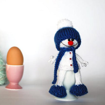 Lovely and sweet Snowman in the blue hat and scarf for keeping warm breakfast egg
