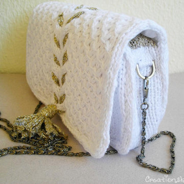 White knit clutch with gold tassel