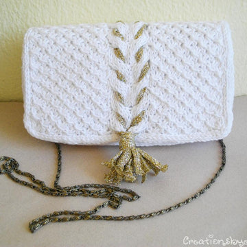 White knit clutch with gold tassel