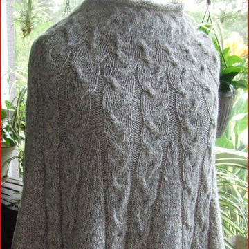 Cabled poncho with cuffs