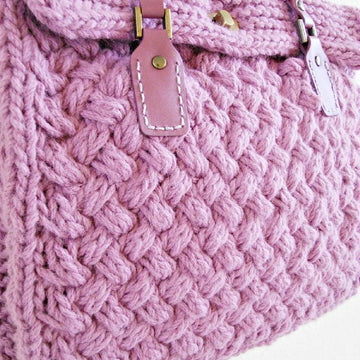 Textured bag knitted with woven pattern