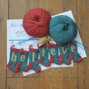 BELIEVE Set of 7 Christmas Stocking Ornaments