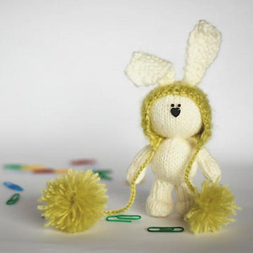 White rabbit in a light green hat