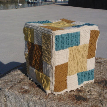 Knitted patchwork cushion, footstool, draught excluder, rug, living room collection