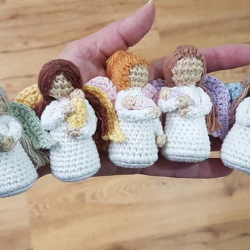 Miniature Angel holding baby