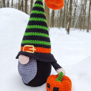 Halloween black gnome with pumpkin